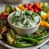 Vibrant Little Sprout Veggie Platter with fresh baby carrots, snap peas, and cucumber slices arranged around creamy Green Goddess dip.  
