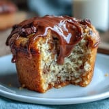 Golden banana muffins with melty chocolate chips and a hint of sourdough tang, perfect for a cozy breakfast treat.