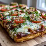 Kentucky Derby Hot Brown Flatbread Pizza with turkey, bacon, and creamy Mornay sauce baked until bubbly and golden.