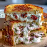 Creamy pimento cheese finger sandwiches stacked on a platter for Derby parties and Southern gatherings.