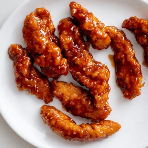 A close-up of a Honey Sriracha Chicken Wrap, sliced to reveal juicy chicken and crunchy vegetables.