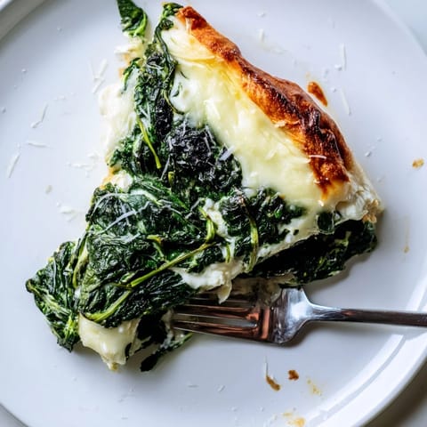 Spinach Ricotta Pizza is garnished with red pepper flakes and served with a fresh salad on the side.