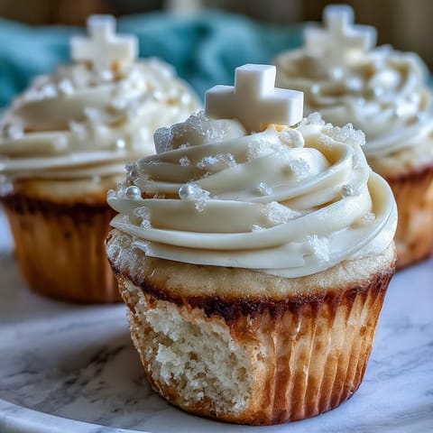 Communion cupcakes with white fondant cross toppers, vanilla buttercream frosting on soft cupcakes.