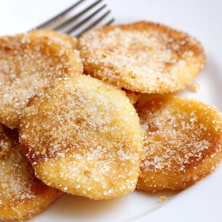 Warm and crispy fried dough, piled high and ready to enjoy with a drizzle of honey.