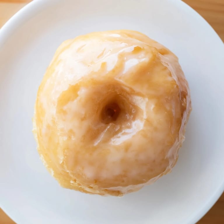 Close-up shot shows light and airy glazed yeast donuts, ideal for a sweet breakfast.