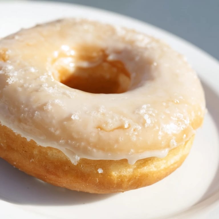 A plate of fluffy cake donuts with a variety of toppings, ready to enjoy anytime.