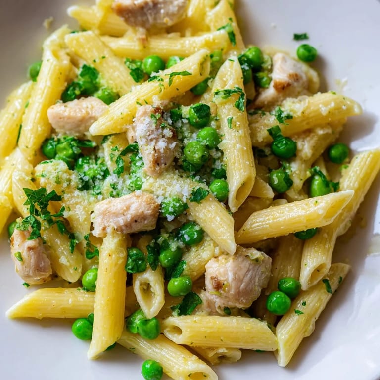Serving suggestion for Pea & Mint Chicken Pasta, paired with a crisp white wine on a bright, spring-inspired table setting.