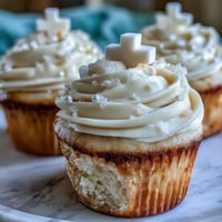 Communion cupcakes with white fondant cross toppers, vanilla buttercream frosting on soft cupcakes.